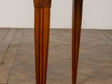 a wooden table with two legs on a parquet floor