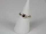 a close up of a ring on a cone on a white surface
