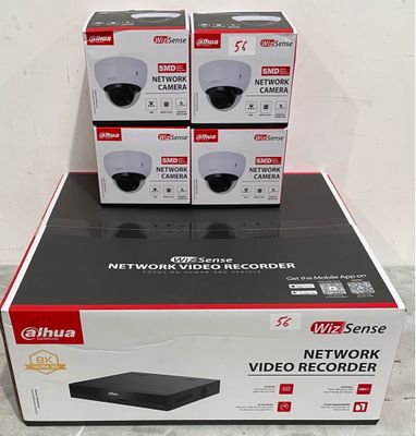 four black and white boxes of video recorders stacked on top of each other