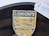 a black plate with a gold and black badge on it