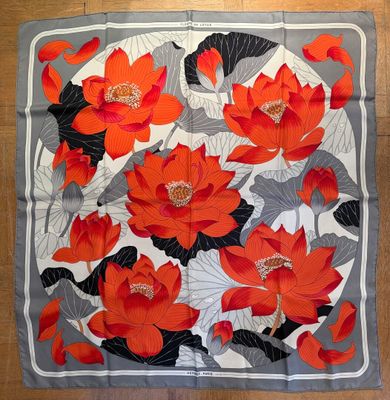 a close up of a square scarf with red flowers on it