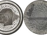 a close up of a coin on a white background with a picture of a man