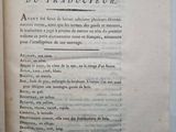 a book open on a table with a pen and paper