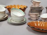 many different types of dishes and cups on the table