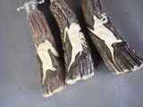 two pieces of wood that have been carved with animals on them