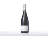 a bottle of wine sitting on top of a white table