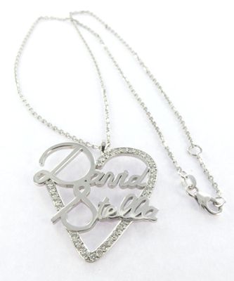 a close up of a necklace with a heart on it