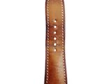 a close up of a brown leather watch strap with white stitching