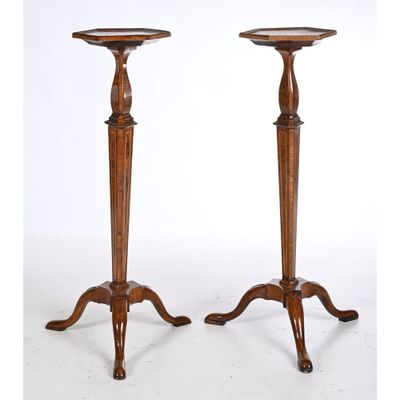 a pair of tall wooden candlesticks with turned legs