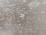 a close up of a metal surface with a hole in it