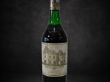 a bottle of wine sitting on top of a black table