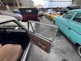many cars parked in a parking lot next to each other