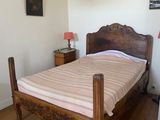 a bed with a wooden frame in a small room