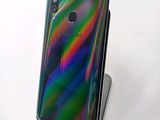 the back view of a phone with a multicolored design on it