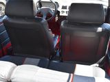 two seats in the back of a car with a steering wheel