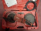 a tool in a red case with a cord