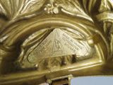 a close up of a gold statue with a triangle on it
