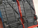 two red and blue plastic crates with wheels on them