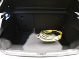 the trunk of a car with a yellow hose in the trunk