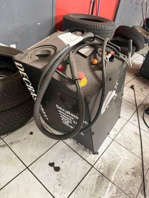 a tire dryer sitting on the floor next to a pile of tires