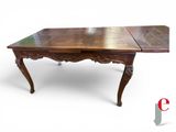 an image of a wooden table with two leaves on top of it