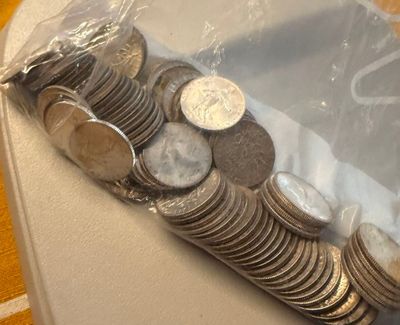 a bag of coins sitting on a table next to a pile of coins