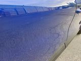 a blue car parked on the side of the road