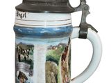 a beer mug with pictures on it sitting on a table
