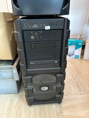 a black computer tower with a monitor on top of it
