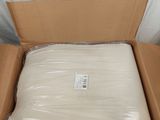 a cardboard box with a mattress inside of it