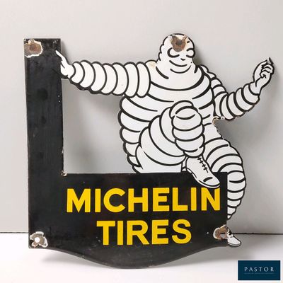 a sign that says michel tires with a picture of a man in the middle of it