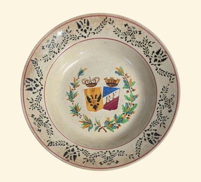 a plate with a coat of arms and a crown on it