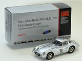 a silver model of a car next to a boxed box