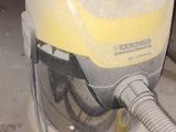 a yellow and white vacuum sitting on the floor