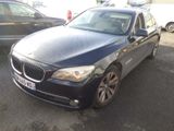a picture of a black bmw car parked in a parking lot