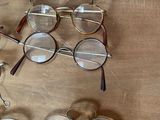 many pairs of glasses sitting on a table