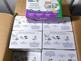 several boxes of baby diapers sitting on top of a cardboard box