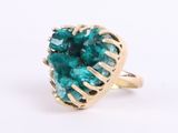 an image of a gold ring with a green tourmaline stone
