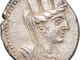 a silver coin with an image of a woman wearing a crown on it