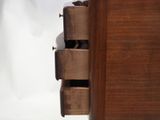 a close up of a wooden drawer with three drawers