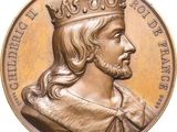 une image représentant une médaille d'or sur laquelle figure un homme coiffé d'une couronne