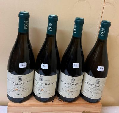six bottles of wine are lined up on a wooden stand