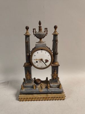 a small clock that is sitting on a table