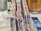 several toothbrushes, toothpaste, toothpaste, toothpaste, toothpaste, toothpaste, toothpaste, toothpaste