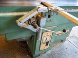 a machine that is cutting a piece of wood