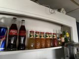 a shelf that has a lot of drinks and sodas on it