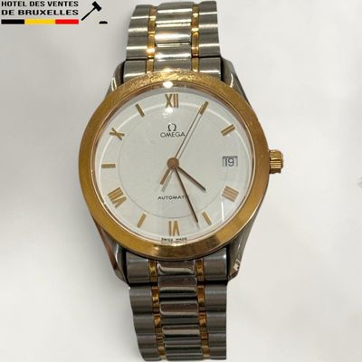 a gold and silver watch with roman numerals on it