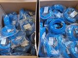 two boxes of blue cables are stacked on top of each other