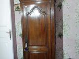 a tall wooden cabinet in the corner of a room