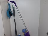 a mop and a broom in the corner of a room